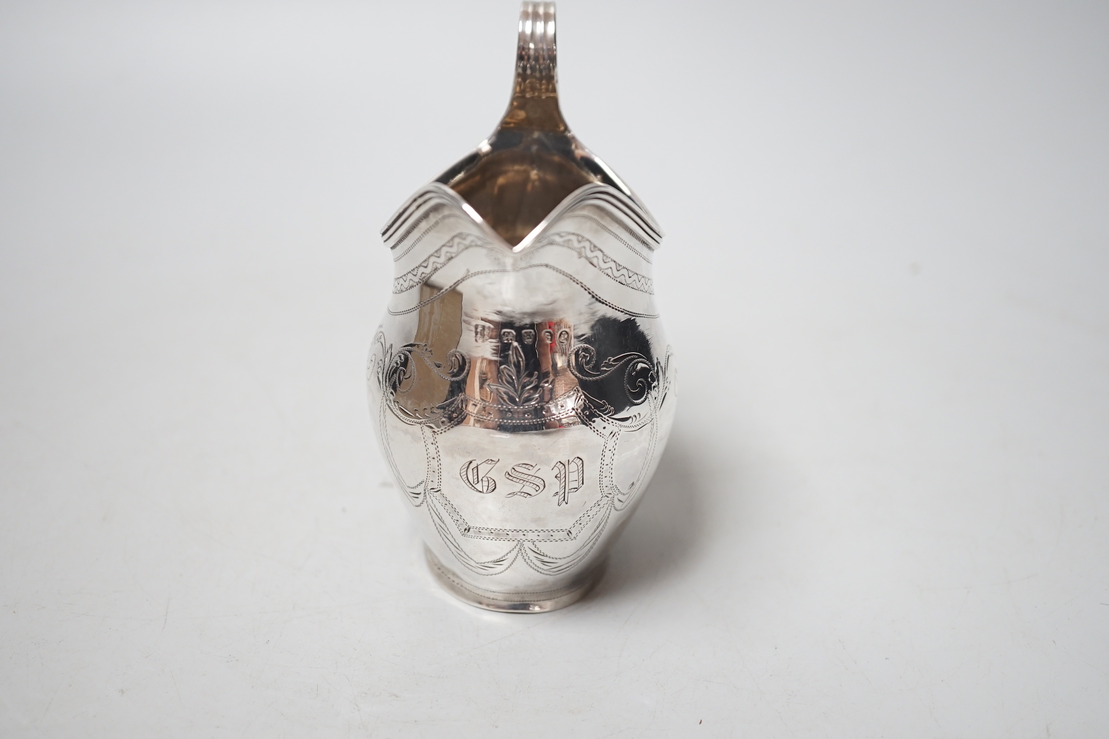 A George III engraved silver helmet shaped cream jug, Peter, Ann & William Bateman, London, 1802, 12.2cm, 108 grams.